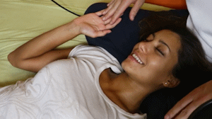 A woman in a state of deep peace and energy flow during a tantra healing session